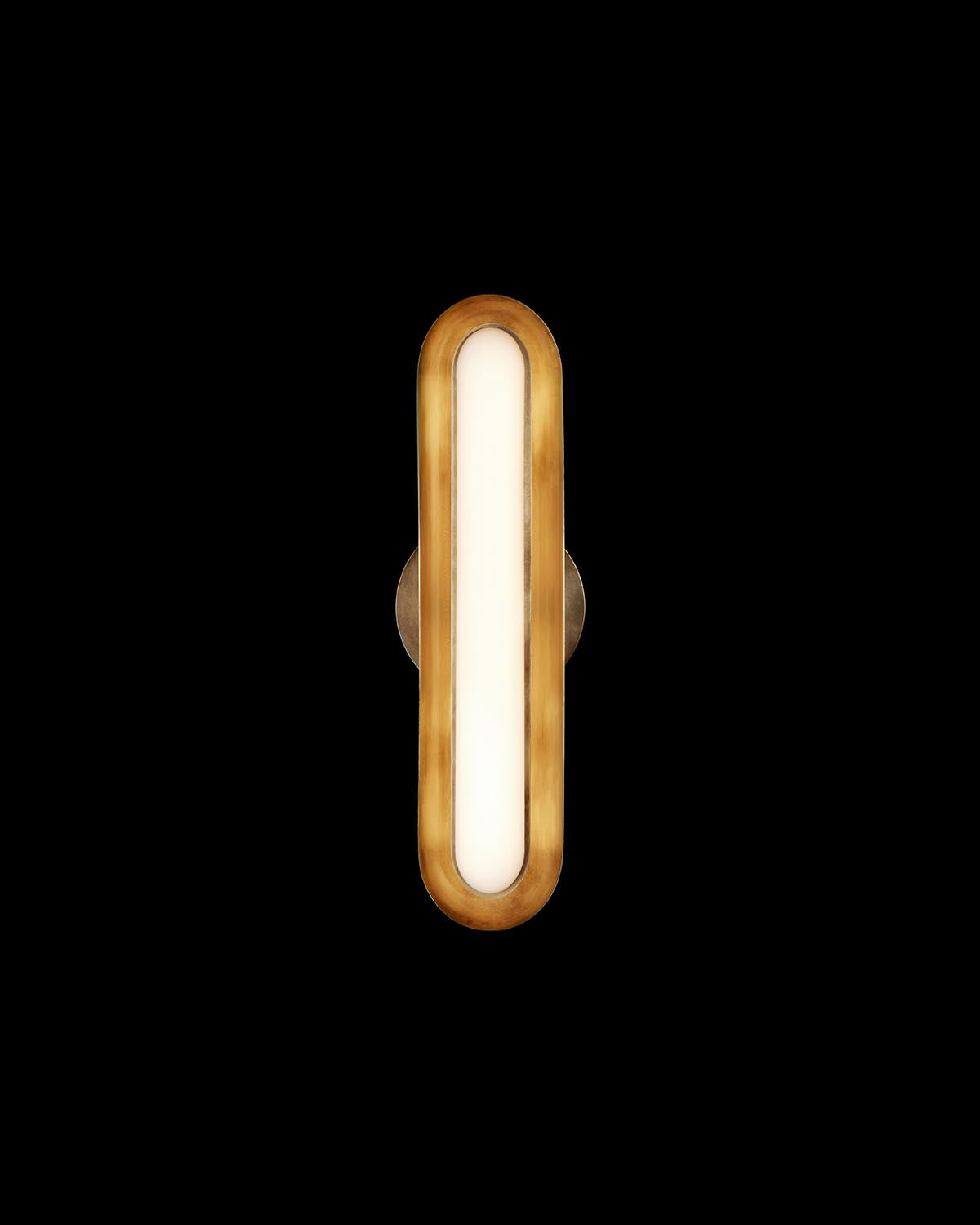 Oval-shaped modern wall light with warm golden metal frame and diffused white glass center on black background