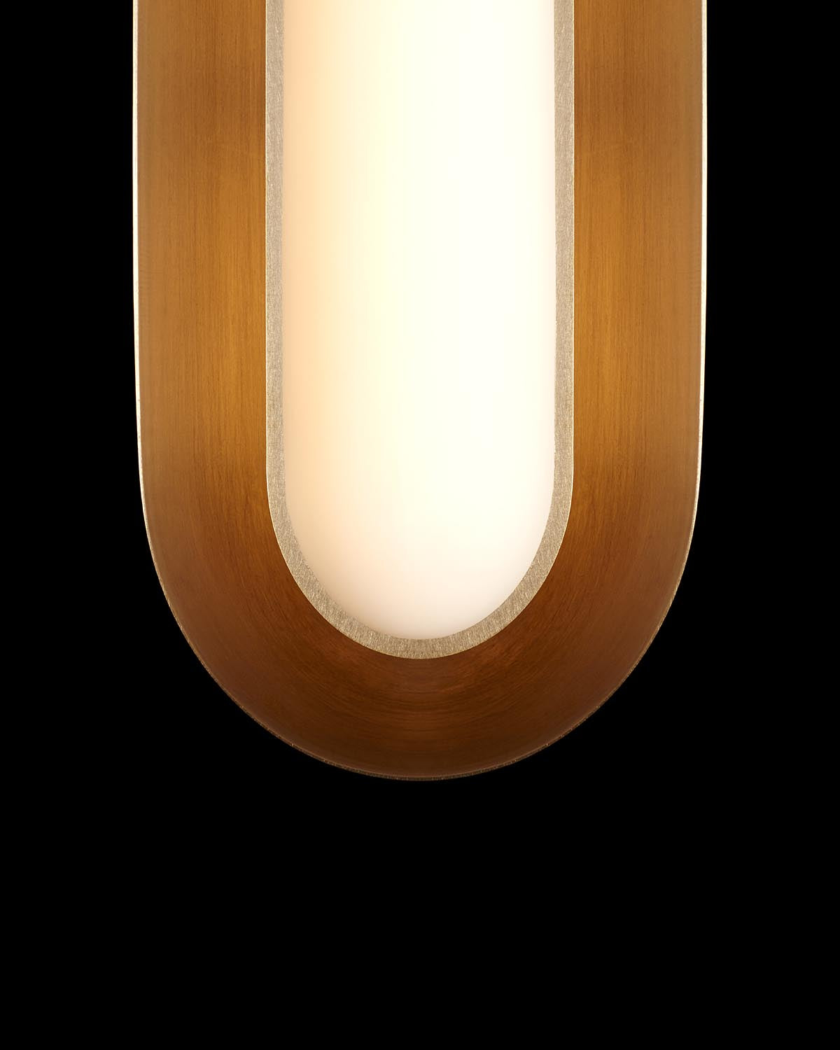 Close-up of elongated oval light fixture with warm wooden frame and glowing white diffuser against black background