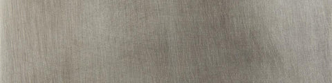 Close up of tarnished silver material swatch.