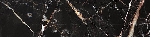 Dark black marble surface with white and brown veining patterns creating an elegant natural stone texture.