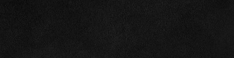 Close-up of a textured black surface with subtle irregular patterns and a matte finish under soft lighting
