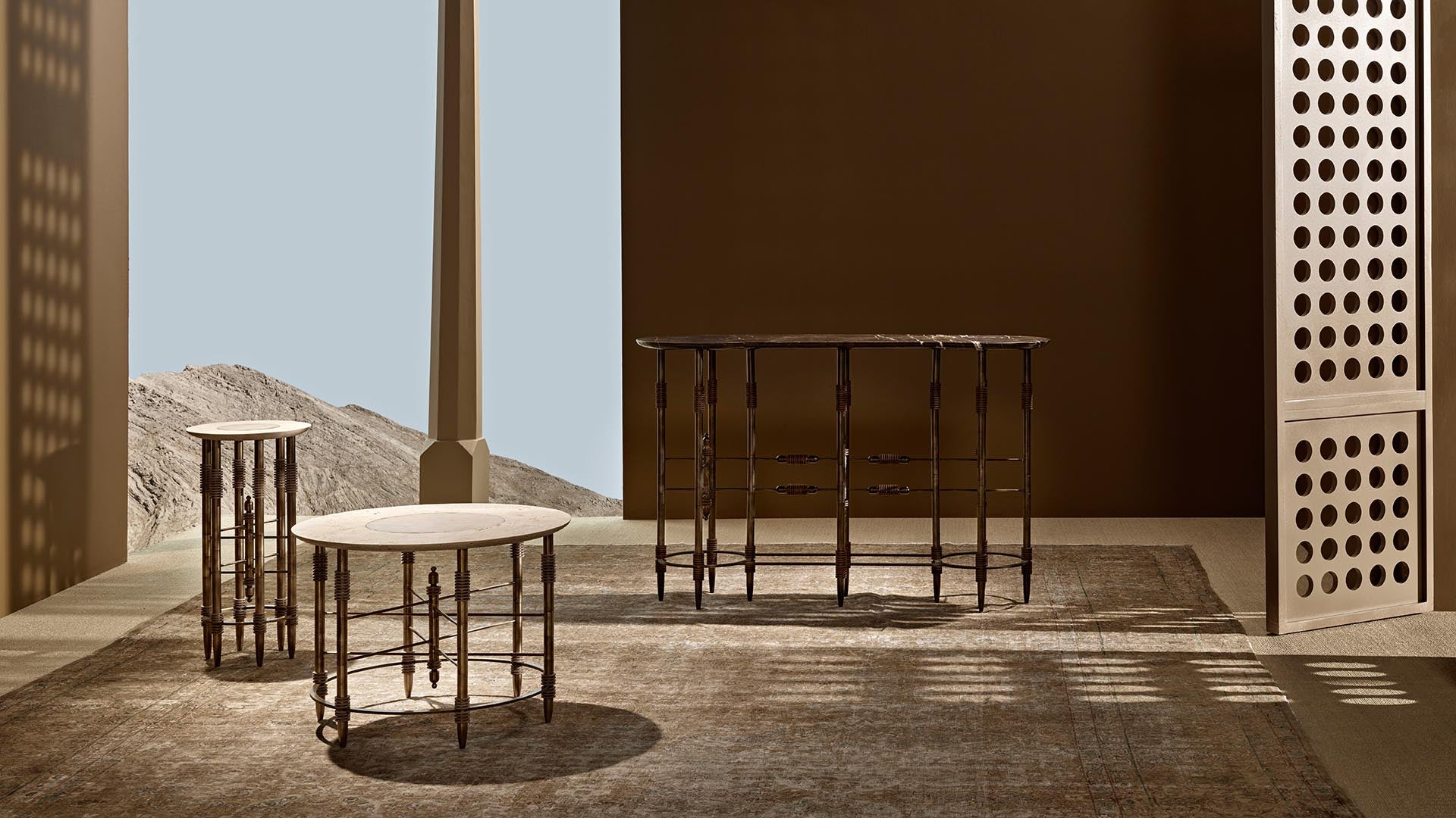 Three wooden tables with round tops and spindle legs arranged on a textured rug near a perforated wooden screen
