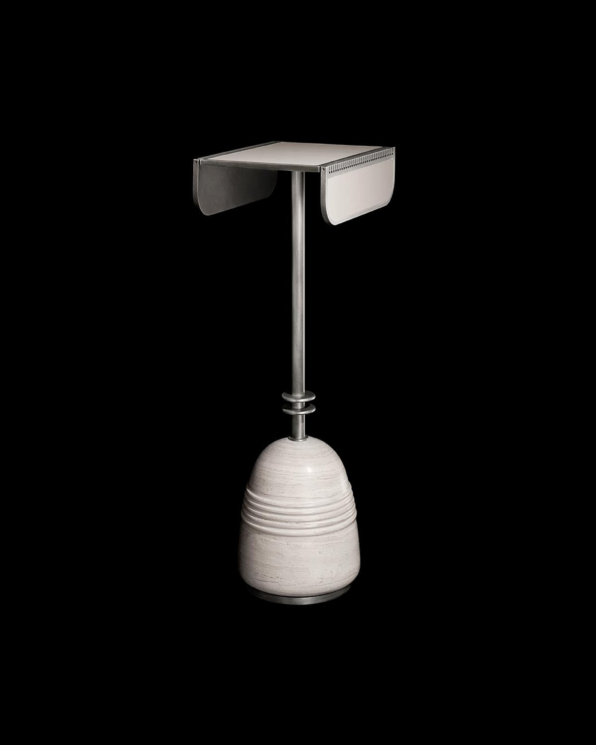 Minimalist cocktail table with a square metal top, slender vertical support, and rounded textured stone base on black background